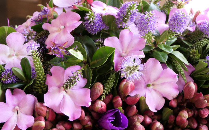 Meaningful floral tribute with purple flowers-